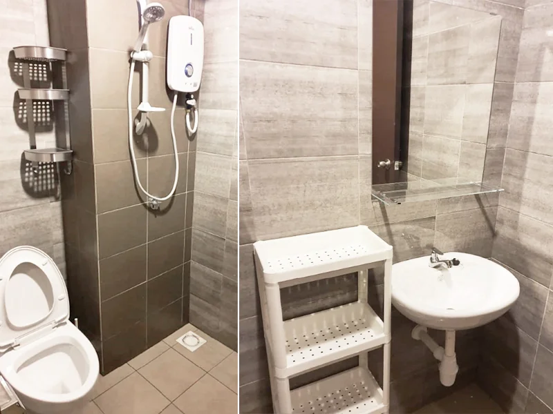 Bathroom features: grey tile flooring, grey wall tiles, white toilet, shower area with glass partition, handheld shower head, wall-mounted shower heater, mirror above sink, white sink with pedestal, plastic shelving unit, chrome faucet; style: modern.